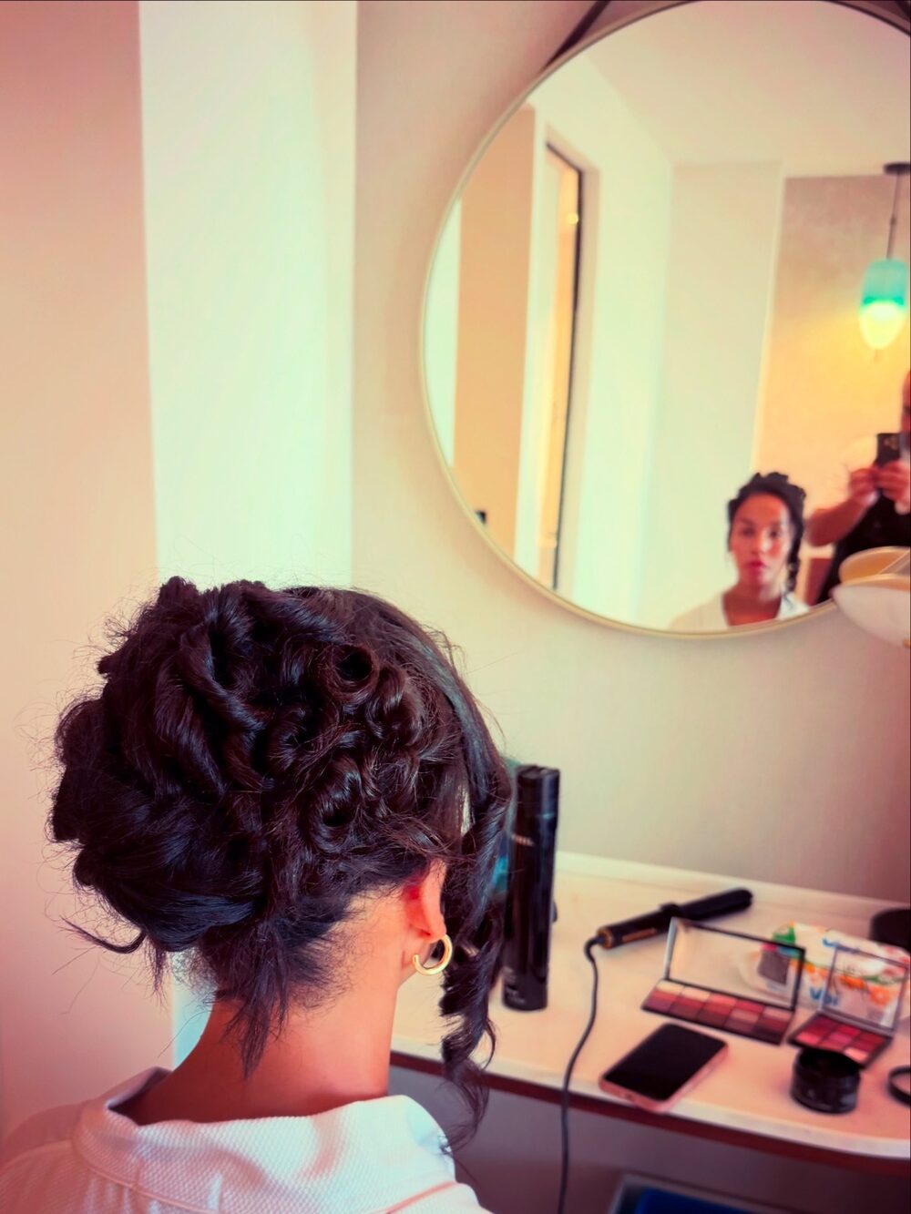 Bridal updo in the mirror, styled on location