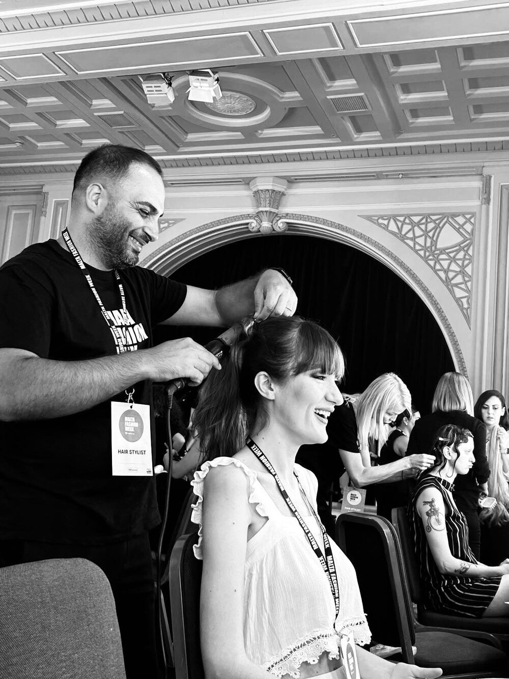 Francesco Varamo styling a model backstage at Malta Fashion Week